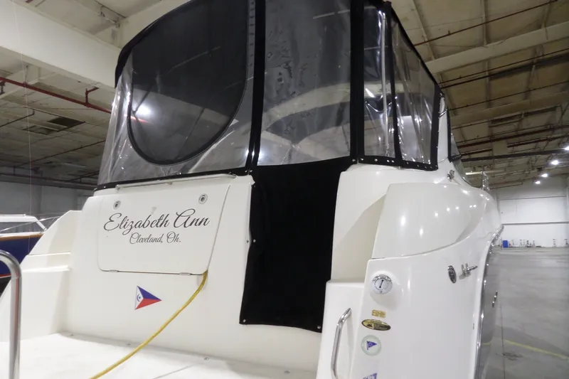 Slide: The Image of 2008 Bayliner 320 Cruiser docked indoors, featuring "Elizabeth Ann" on the stern. - 4