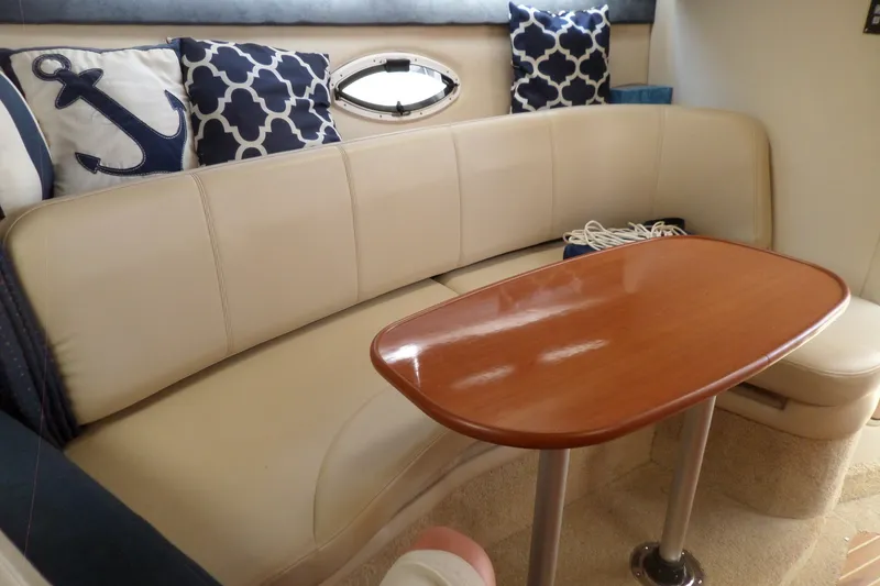 Slide: The Image of Interior of 2008 Bayliner 320 Cruiser with beige seating and nautical-themed pillows. - 36