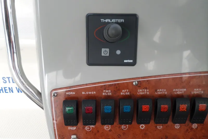 Slide: The Image of Control panel of a 2008 Bayliner 320 Cruiser with thruster and various switches. - 9