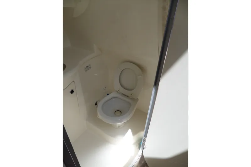 Slide: The Image of Bathroom interior of 2008 Bayliner 320 Cruiser, featuring a compact toilet. - 38