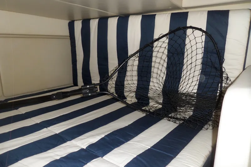 Slide: The Image of Striped boat interior with fishing net on Bayliner 320 Cruiser, 2008 model. - 47