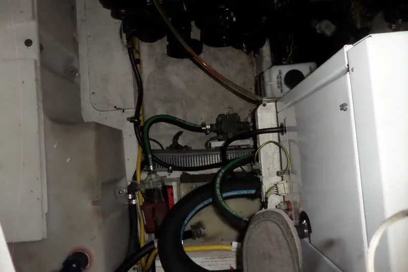 Slide: The Image of Engine compartment of a 2008 Bayliner 320 Cruiser, showing hoses and mechanical components. - 56