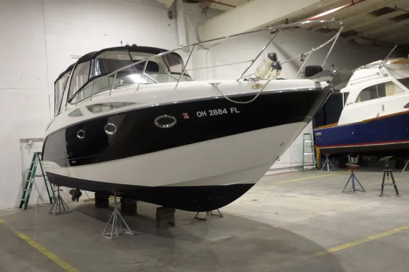 Slide: The Image of 2008 Bayliner 320 Cruiser in storage, elevated on stands in a warehouse. - 5