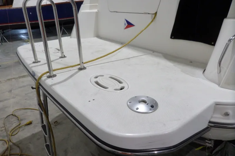 Slide: The Image of 2008 Bayliner 320 Cruiser swim platform with ladder and power cable. - 6