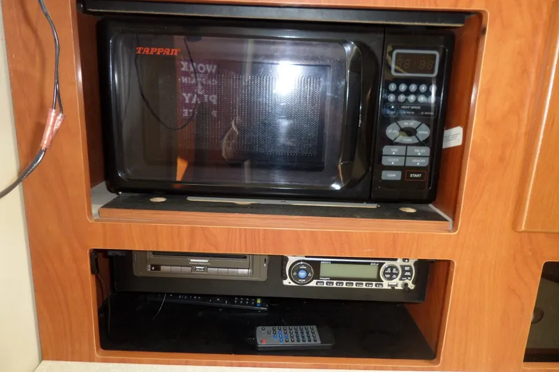 Slide: The Image of Microwave and stereo system in 2008 Bayliner 320 Cruiser's wooden interior. - 51