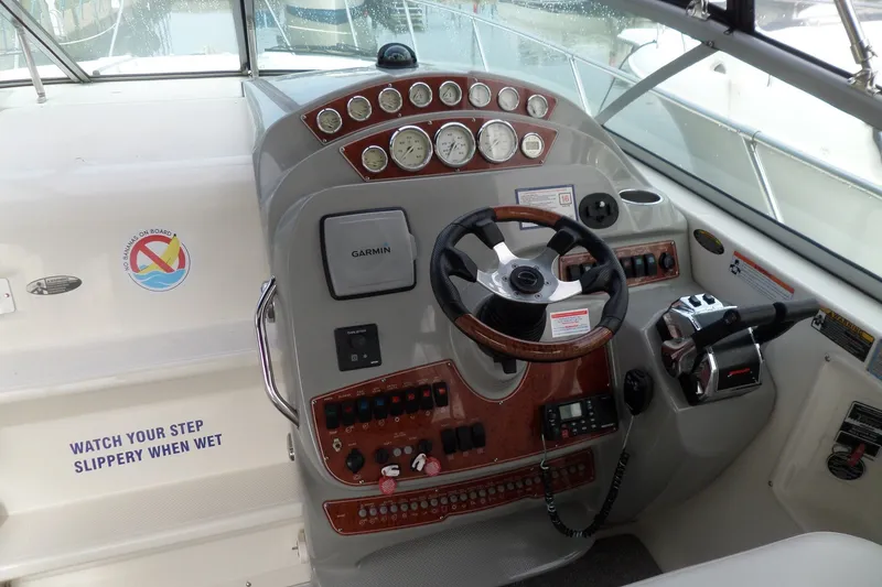 Slide: The Image of 2008 Bayliner 320 Cruiser helm with steering wheel, gauges, and controls. - 10