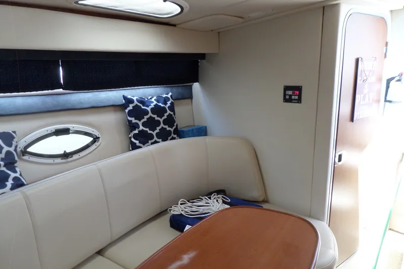 Slide: The Image of Interior of 2008 Bayliner 320 Cruiser with seating, table, and nautical decor. - 35
