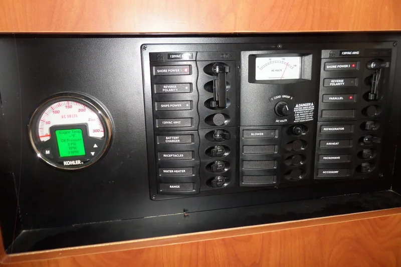 Slide: The Image of Control panel of a 2008 Bayliner 320 Cruiser, featuring various switches and gauges. - 42