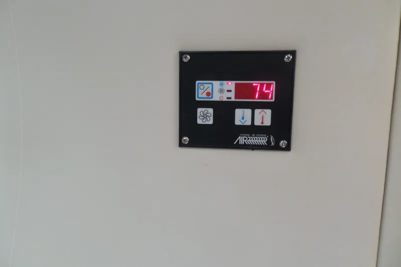 Slide: The Image of Control panel on a 2008 Bayliner 320 Cruiser displaying temperature at 74 degrees. - 54