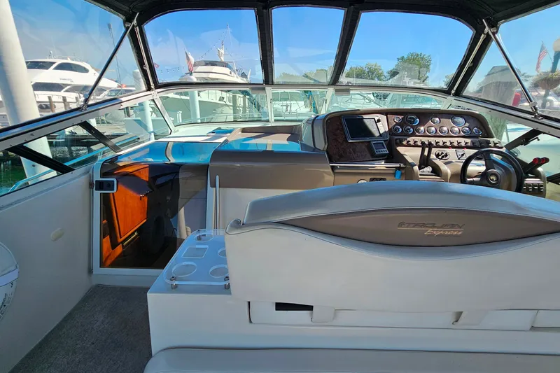 Slide: The Image of 1998 Trojan 400 Express boat cockpit with steering wheel and control panel. - 13
