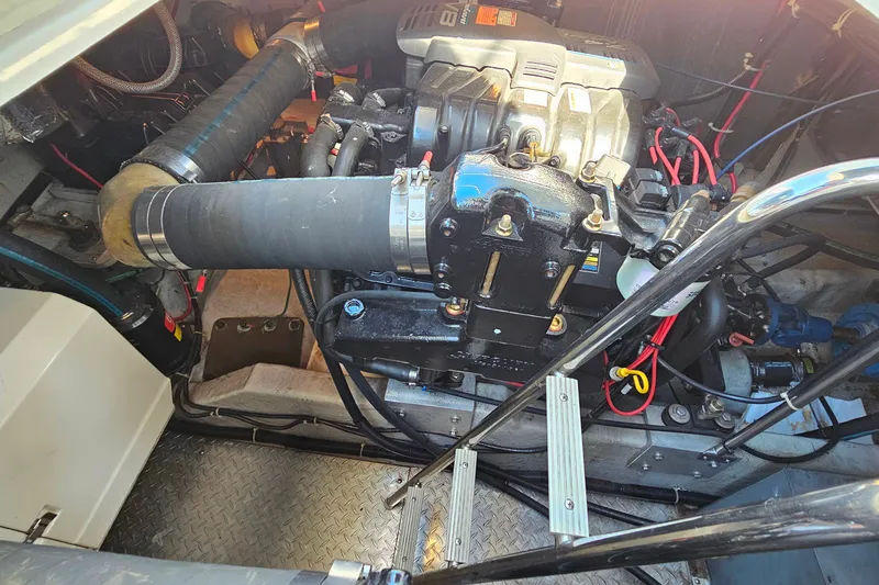 Slide: The Image of Engine compartment of a 1998 Trojan 400 Express boat, showcasing mechanical components and wiring. - 25