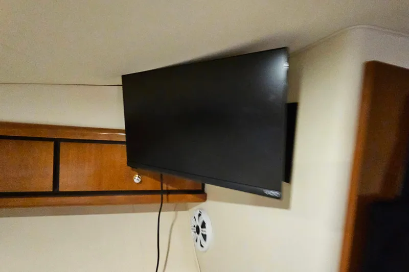Slide: The Image of Flat-screen TV mounted in a 1998 Trojan 400 Express boat interior. - 41
