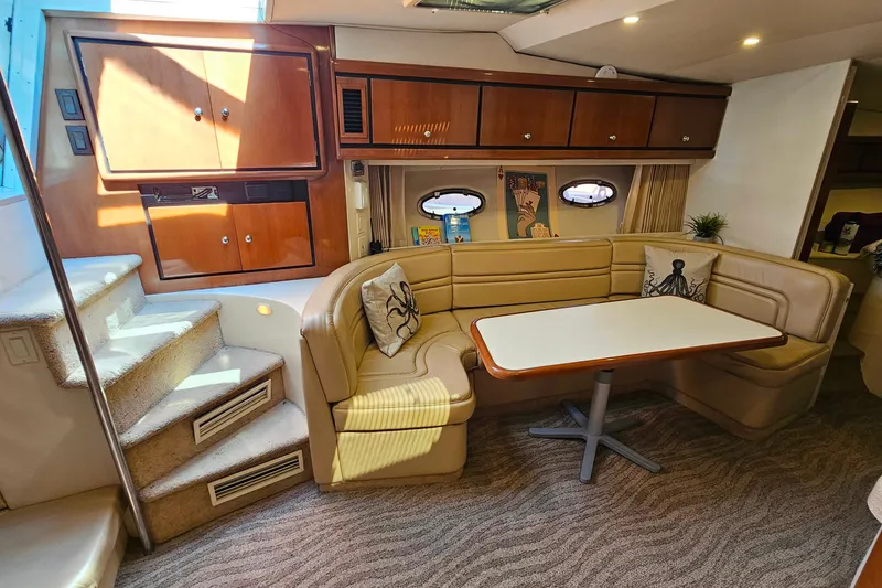 Slide: The Image of 1998 Trojan 400 Express yacht interior with cozy seating and elegant wood cabinetry. - 30