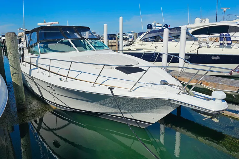 Slide: The Image of 1998 Trojan 400 Express yacht docked at marina under clear blue sky. - 43