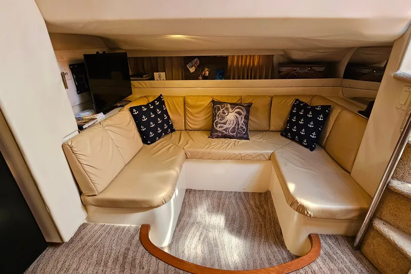 Slide: The Image of Luxurious interior of 1998 Trojan 400 Express yacht with beige seating and nautical decor. - 33