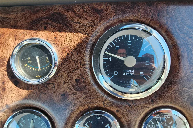 Slide: The Image of Dashboard of a 1998 Trojan 400 Express with RPM and pressure gauges. - 17