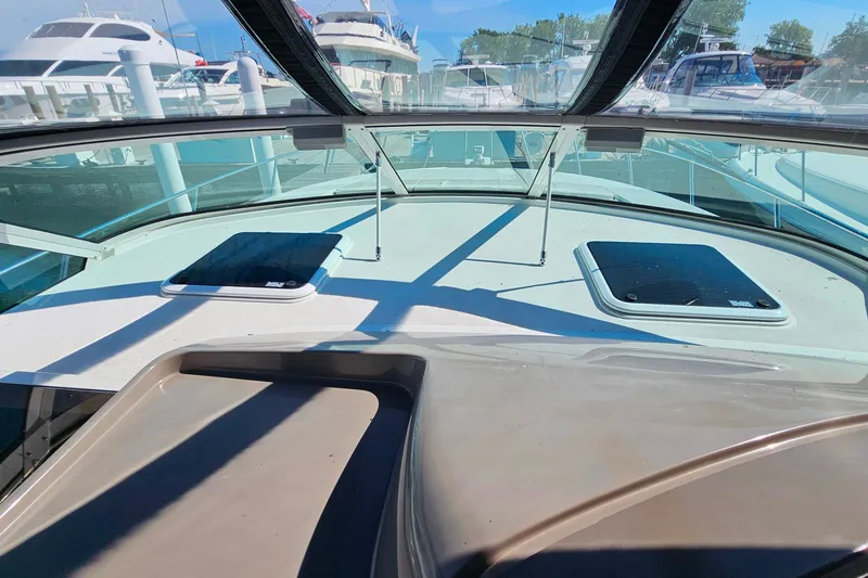 Slide: The Image of 1998 Trojan 400 Express yacht deck view with marina background. - 19