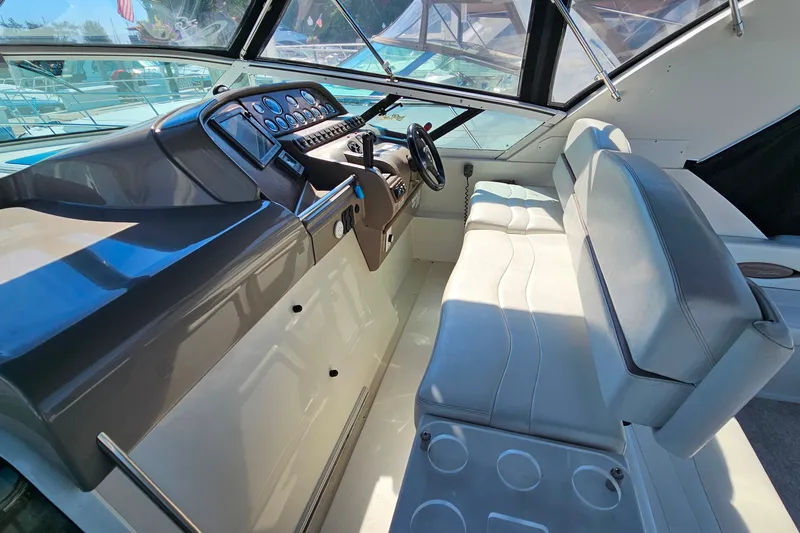 Slide: The Image of Cockpit of 1998 Trojan 400 Express boat with steering wheel and seating. - 15