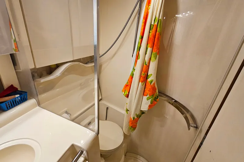 Slide: The Image of Bathroom interior of 1998 Trojan 400 Express yacht with shower and floral towel. - 39