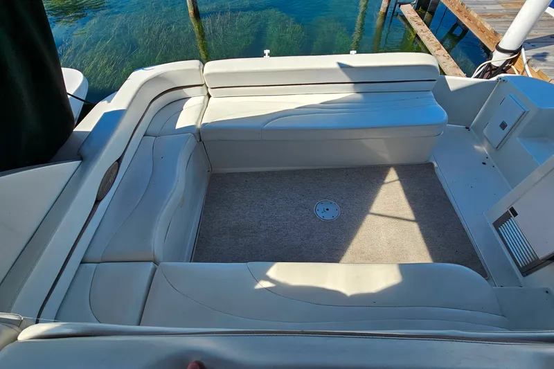Slide: The Image of 1998 Trojan 400 Express boat interior with white seating and carpeted floor. - 21