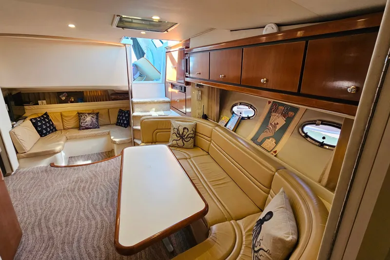 Slide: The Image of Luxurious interior of a 1998 Trojan 400 Express yacht with plush seating and elegant decor. - 35