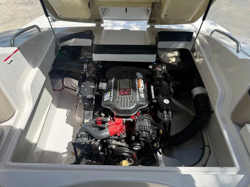 Slide: The Image of The engine compartment of a 2006 Four Winns 240 Horizon with a prominently visible engine. - 17