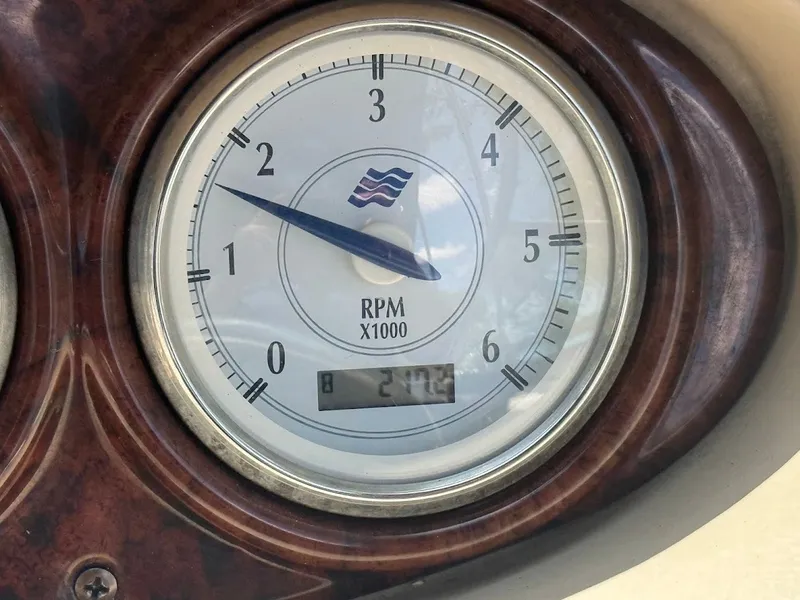 Slide: The Image of Boat tachometer with wave logo, displaying 2,742 RPM. - 27
