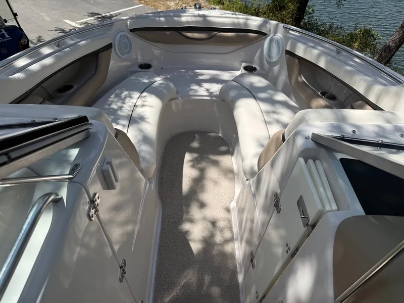 Slide: The Image of The image shows the cockpit of a 2006 Four Winns 240 Horizon boat with beige seating. - 25