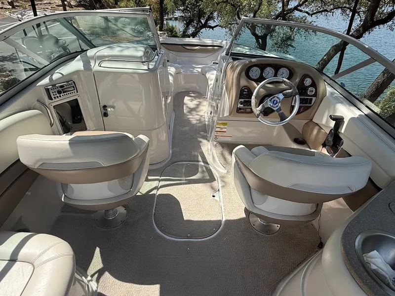 Slide: The Image of The image shows the cockpit of a 2006 Four Winns 240 Horizon boat with beige seats and dashboard. - 19