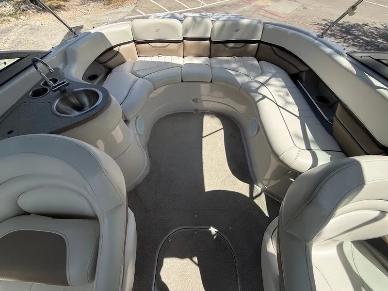 Slide: The Image of Interior of a 2006 Four Winns 240 Horizon with beige upholstery and a sink. - 14