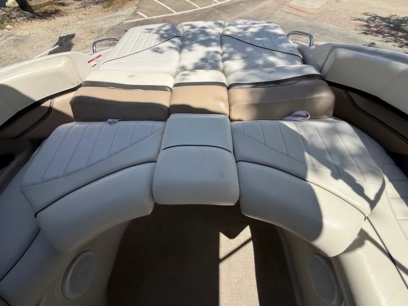 Slide: The Image of The image shows the padded sun deck of a 2006 Four Winns 240 Horizon boat. - 16