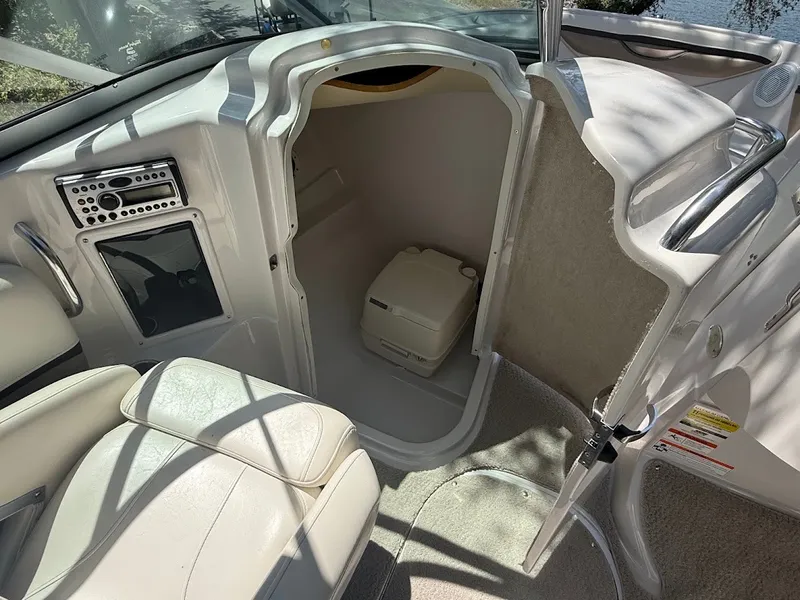 Slide: The Image of The image shows the interior of a 2006 Four Winns 240 Horizon with a small toilet. - 18