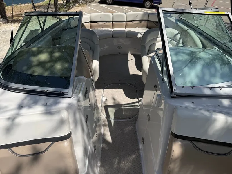 Slide: The Image of The image shows the cockpit of a 2006 Four Winns 240 Horizon with beige seats and glass windows. - 26