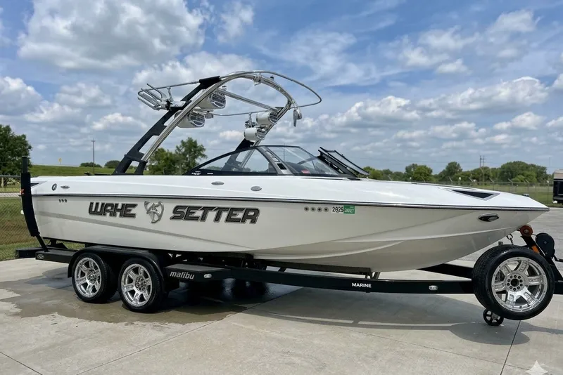 The Image of 2013 Malibu Wakesetter 23 LSV boat on trailer under a cloudy sky. - 0