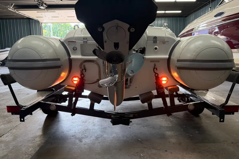 Slide: The Image of 2022 Walker Bay Generation 450 boat on trailer, rear view with visible propeller and lights. - 24