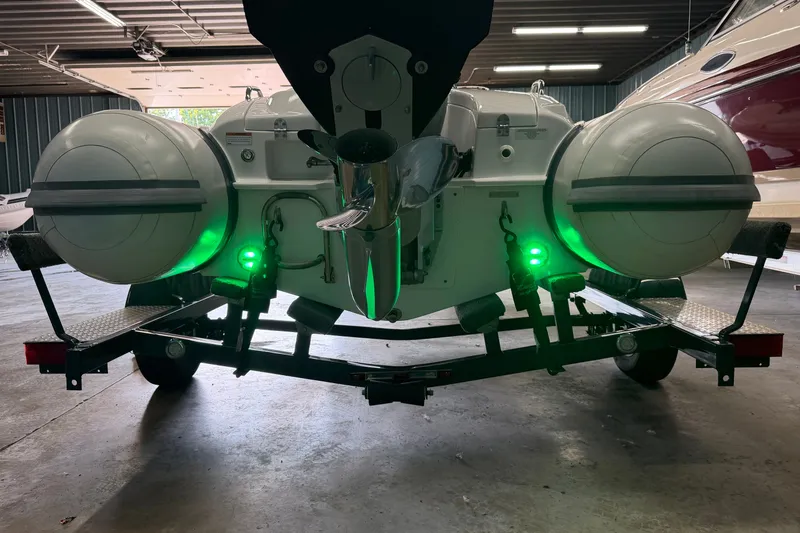 Slide: The Image of 2022 Walker Bay Generation 450 boat on trailer with green lights in a garage. - 23