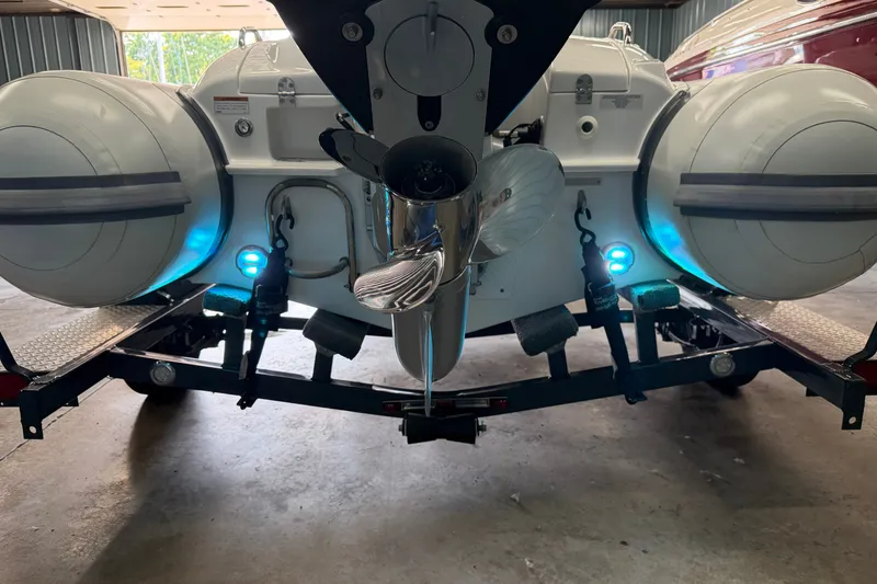 Slide: The Image of 2022 Walker Bay Generation 450 boat rear view with illuminated blue lights. - 25