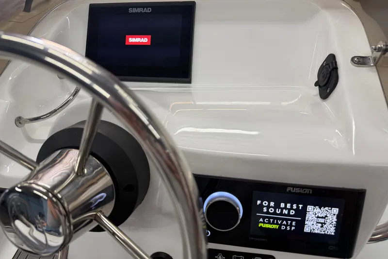 Slide: The Image of Steering console of 2022 Walker Bay Generation 450 with Simrad and Fusion displays. - 21