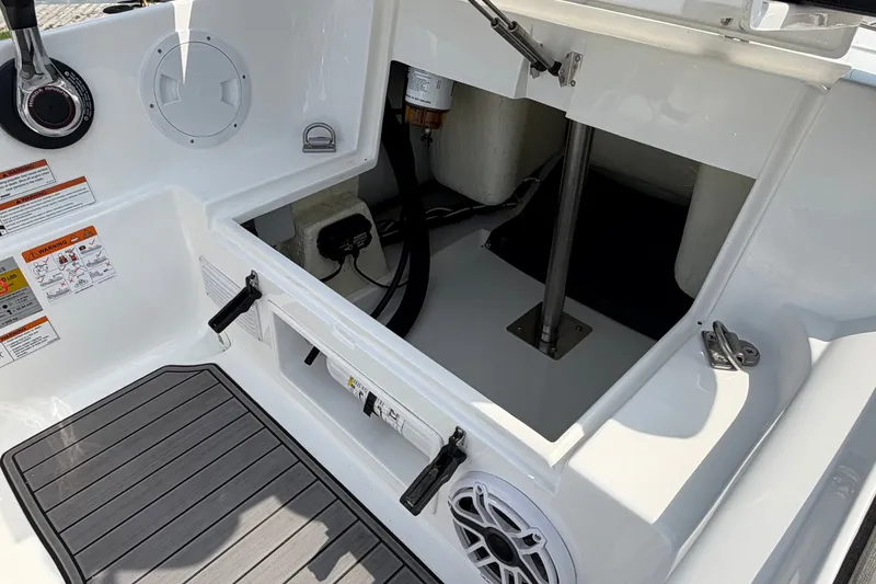 Slide: The Image of 2022 Walker Bay Generation 450 boat interior, showing storage compartment and control panel. - 16