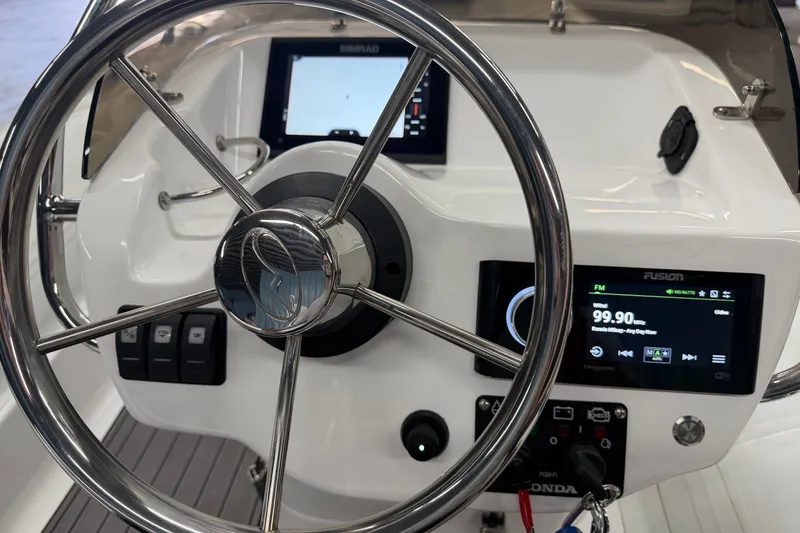 Slide: The Image of Steering console of 2022 Walker Bay Generation 450 with navigation and audio controls. - 20