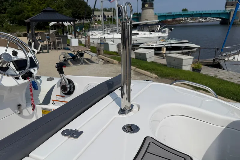 Slide: The Image of 2022 Walker Bay Generation 450 boat interior with steering wheel and waterfront view. - 18
