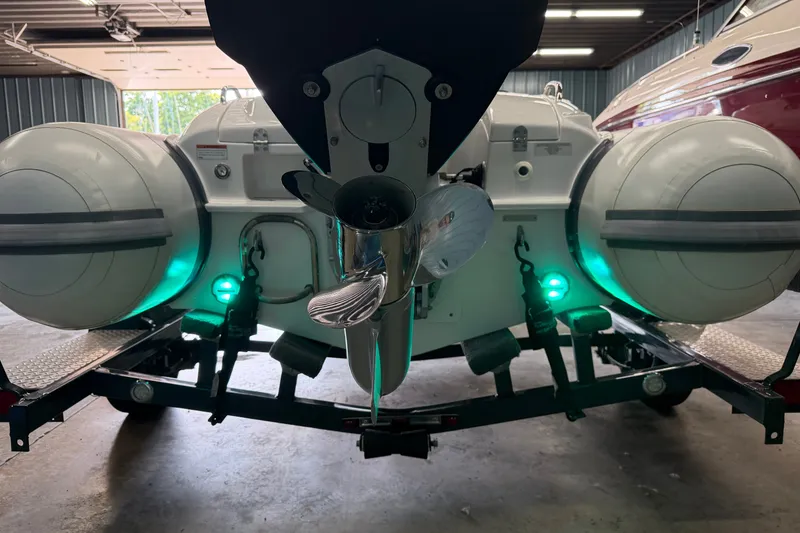 Slide: The Image of 2022 Walker Bay Generation 450 boat on trailer, illuminated with green lights in a garage. - 22