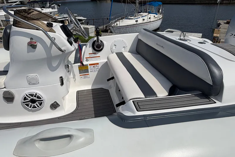 Slide: The Image of 2022 Walker Bay Generation 450 boat interior with sleek seating and control panel. - 15