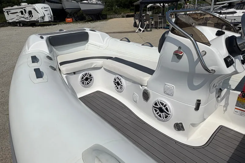 Slide: The Image of 2022 Walker Bay Generation 450 boat interior with seating and control panel. - 14