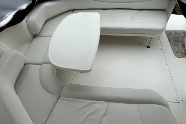 Slide: The Image of Interior seating area of 2003 Sea Ray 380 Sundancer with white upholstery and table. - 9