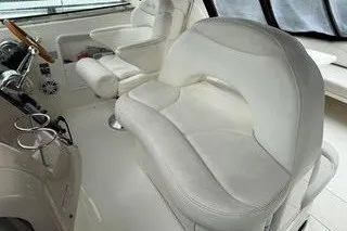 Slide: The Image of 2003 Sea Ray 380 Sundancer interior with white leather seating and helm. - 8