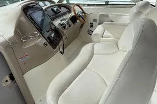 Slide: The Image of 2003 Sea Ray 380 Sundancer cockpit with white leather seating and modern dashboard. - 7