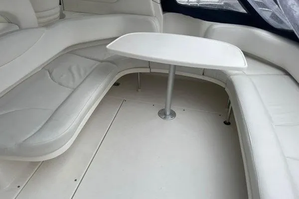 Slide: The Image of 2003 Sea Ray 380 Sundancer interior with white seating and table. - 11