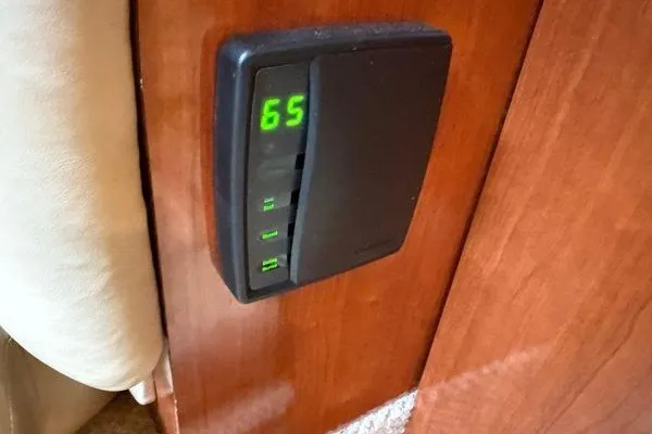 Slide: The Image of Thermostat display on 2003 Sea Ray 380 Sundancer yacht interior, showing temperature at 65 degrees. - 50