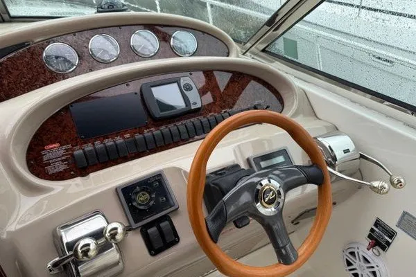 Slide: The Image of Dashboard of a 2003 Sea Ray 380 Sundancer with wooden steering wheel and gauges. - 6